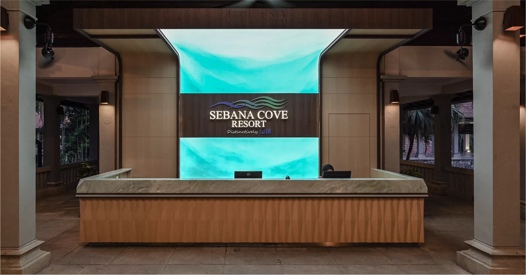 Sebana Cove Resort reception area Sebana Cove Resort reception featuring ocean motif backdrop and sleek wood reception counter, embodying modern hospitality interior design